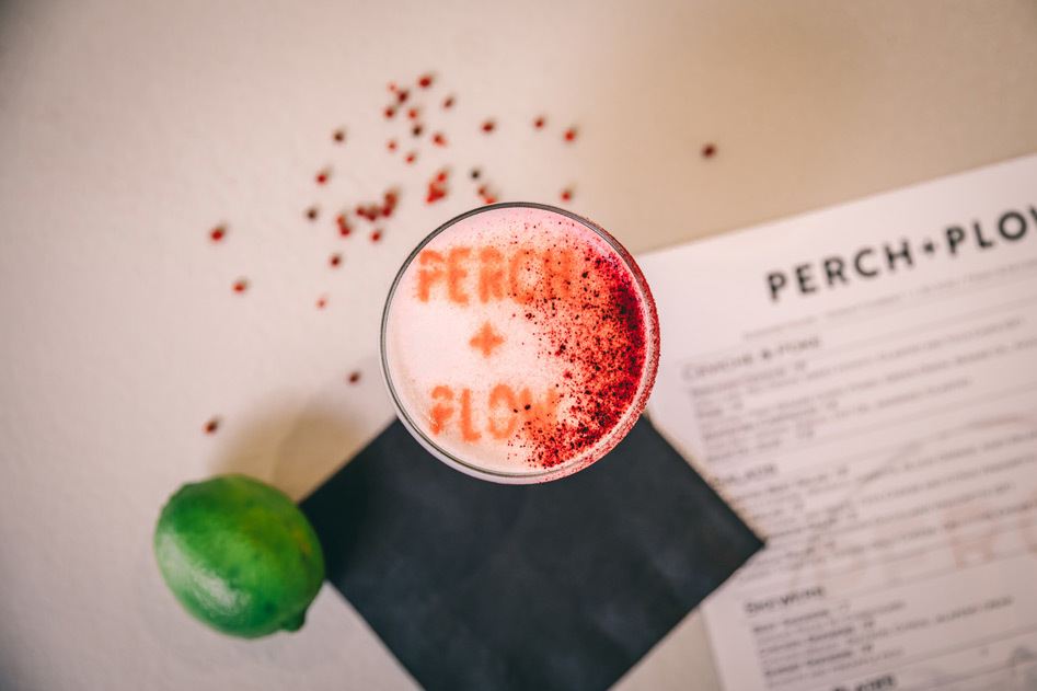 Top down view of a custom cocktail featuring lime and chili powder.