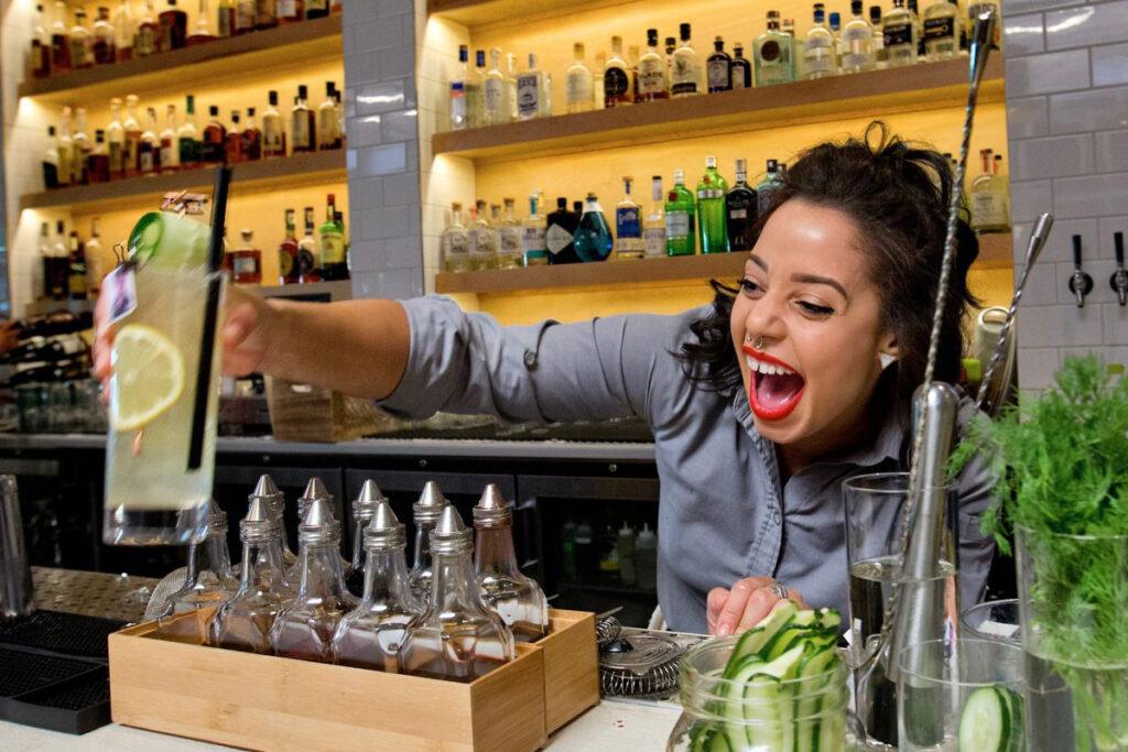 Sonoma Magazine-Eat Here Now. The laughing bartender Bri Hall serves up cocktails at the Perch and Plow on Courthouse Square in Santa Rosa. (photo by John Burgess/The Press Democrat)